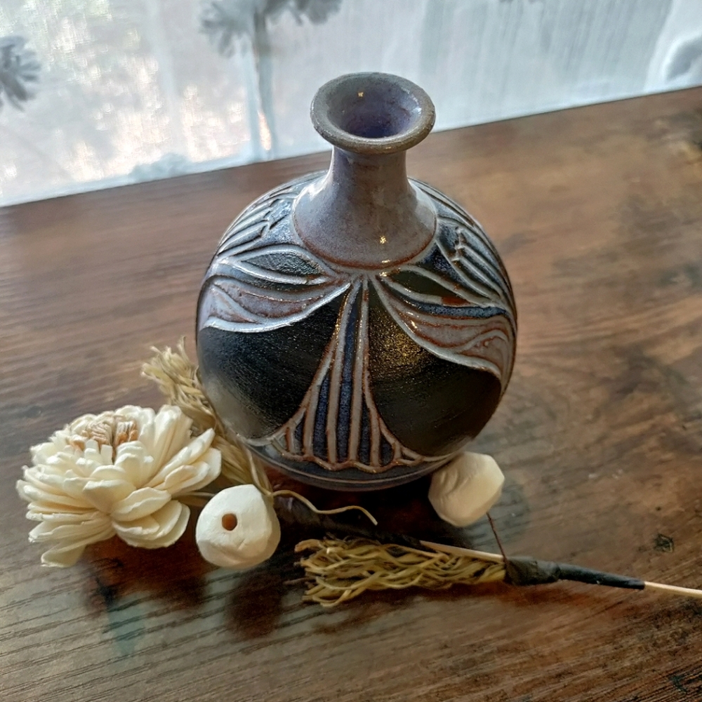 Studio pottery vase with small mouth.